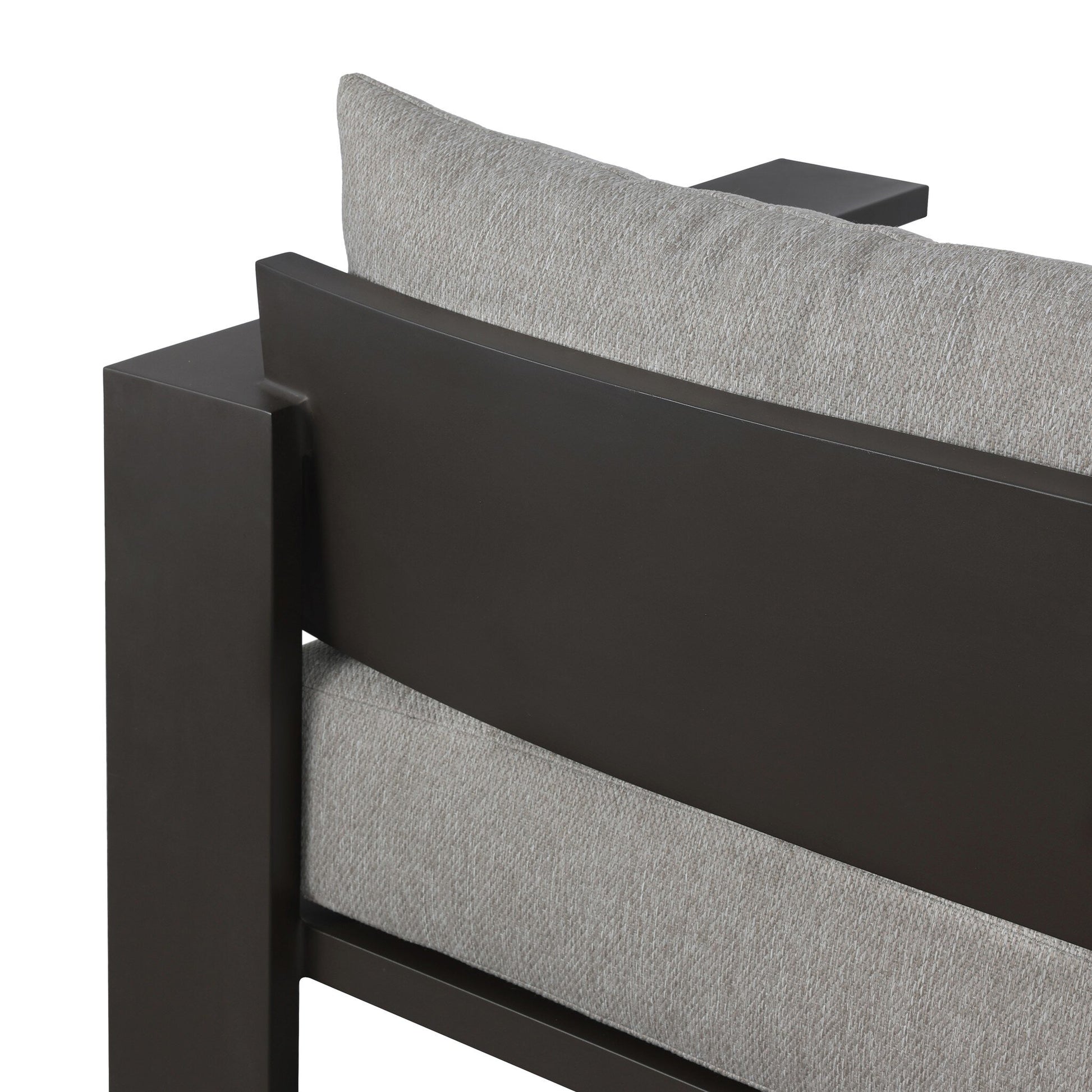 Close-up of the back corner of the Aluminum Angular Detailing | Outdoor Sofa, featuring a traditional silhouette with deep bronze aluminum framing and light gray textured cushions.