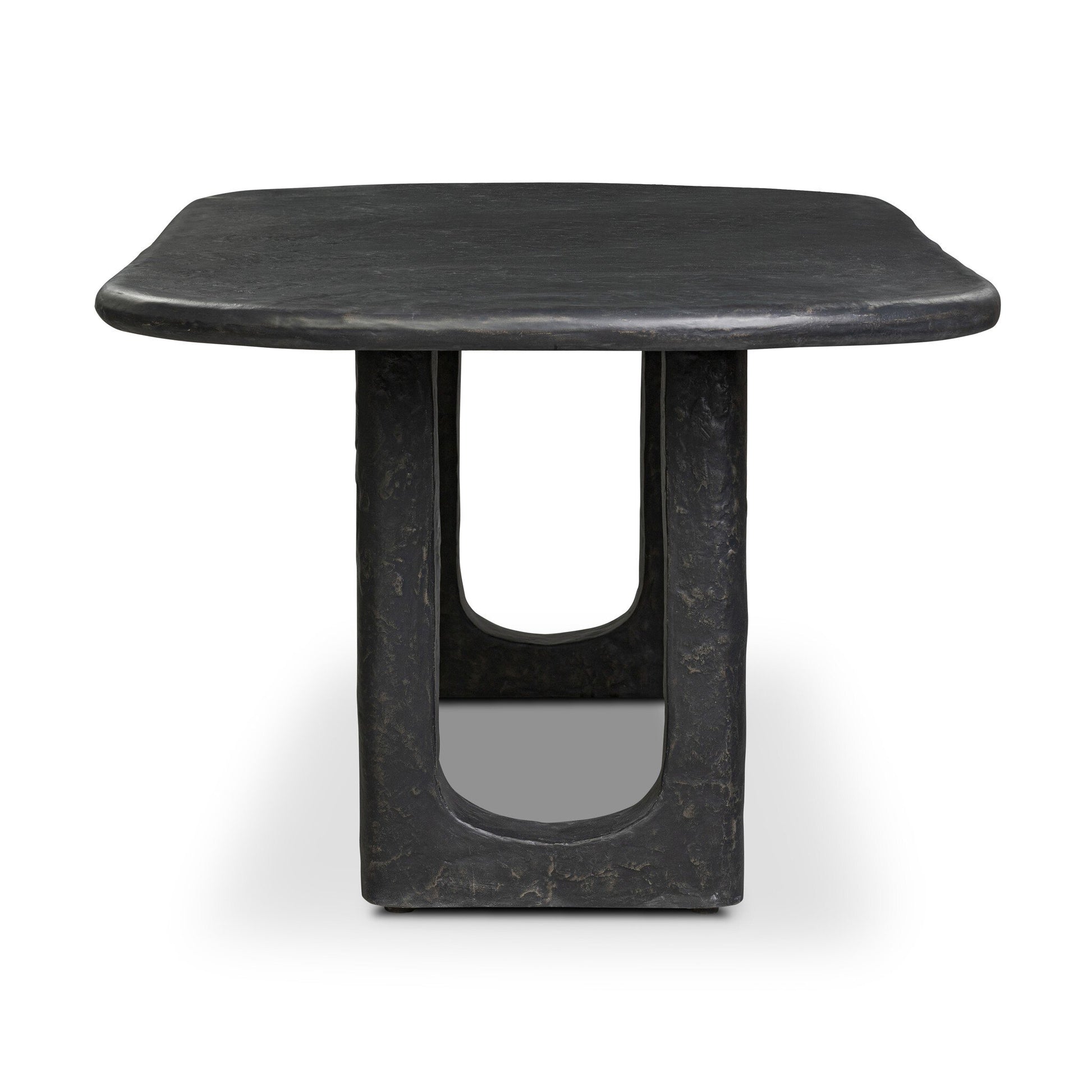 The Obsidian Concrete Softened Rectangle Dining Table features a modern square shape, curved edges, an obsidian-finished concrete base, sculptural central column, and a distinctive open rectangular cutout.