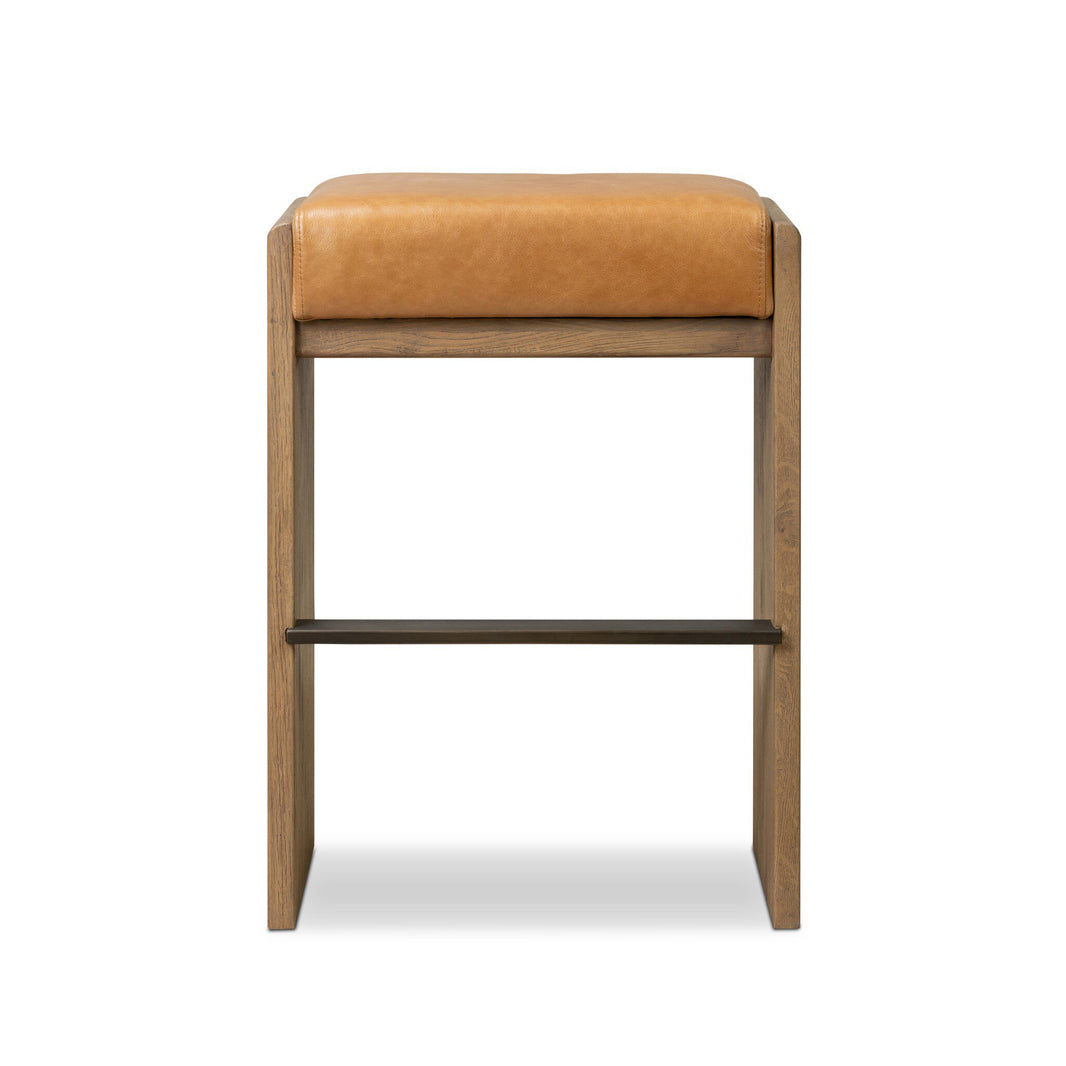 The Nash Bar + Counter Stool features a tan leather cushion and wooden frame, pictured front-facing on a white background. Its sleek design fits perfectly in modern kitchens and dining spaces as a stylish counter stool.