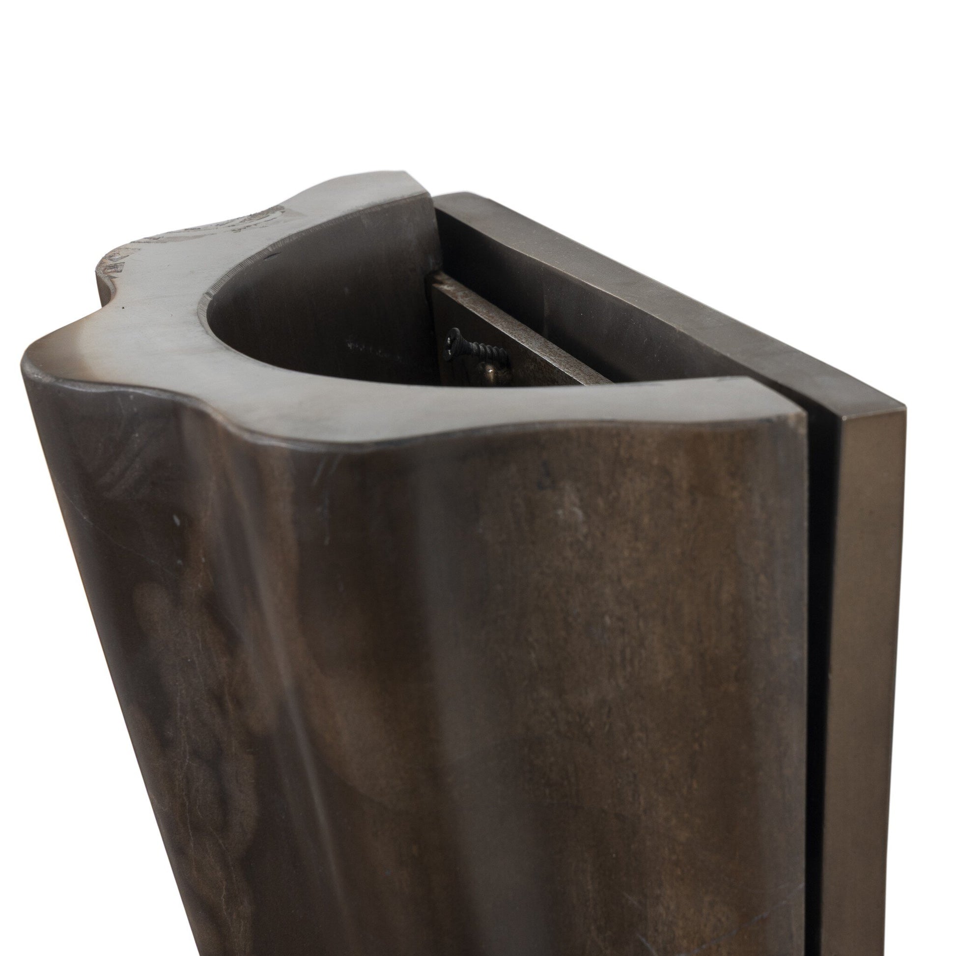 Close-up view of the Astra Sconce, a sculpted dark metal fixture with a smooth, curved edge and rectangular back, featuring overall dimensions of 8.50w x 4.50d x 7.75h.