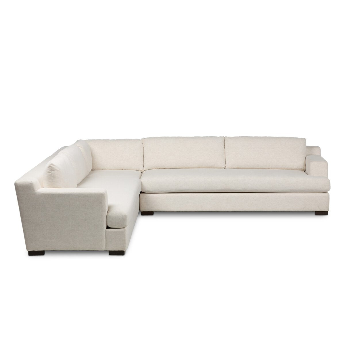The Block Arm Modular Sectional features an L-shaped design with light beige upholstery, three seat and back cushions, and dark wooden block legs—ideal modern living room furniture, shown against a white background.