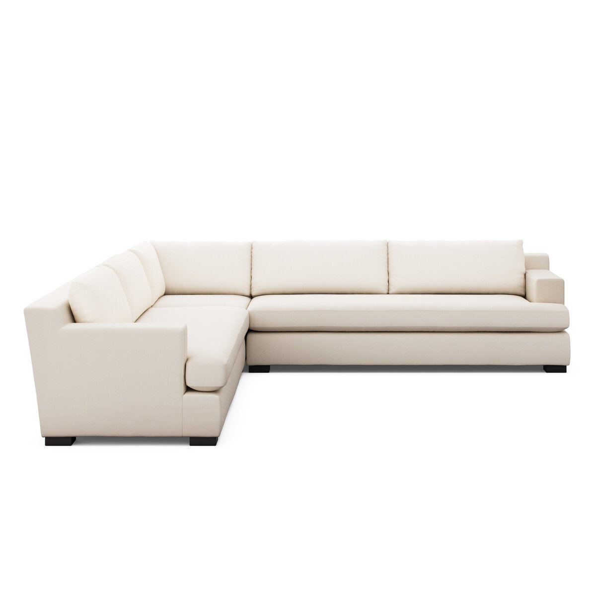 The Block Arm Modular Sectional is a large, modern L-shaped sofa upholstered in cream fabric with low backrests, wide seat cushions, and short black legs, ideal as living room furniture and shown against a white background.