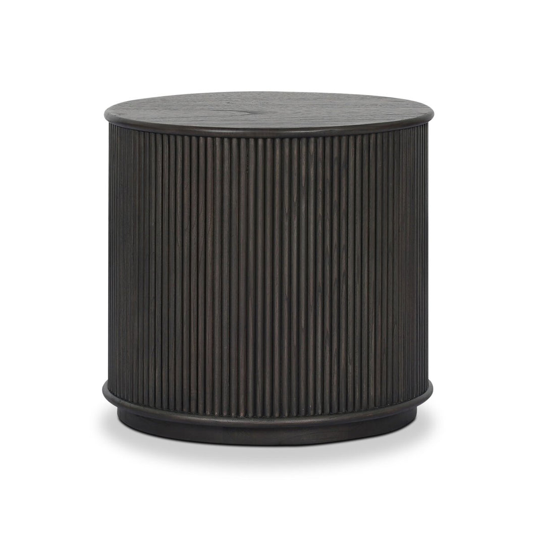The Ona End Table features a round, dark wood design with vertical slats around its base and a smooth, flat top, displayed against a white background.
