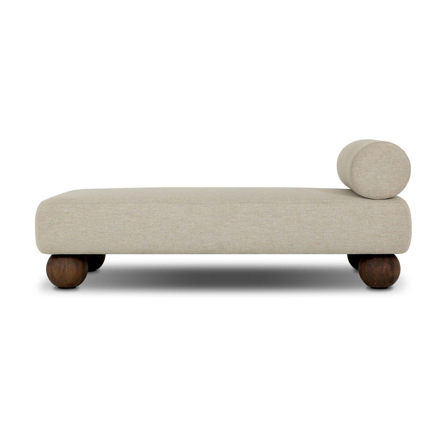 The Leilani Outdoor Chaise features modern beige upholstery, a cylindrical bolster pillow at one end, and four rounded dark wooden legs—ideal beside an office desk or in a contemporary workstation, pictured against a white background.