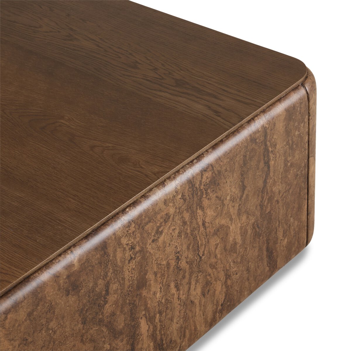 Close-up of the Lola Coffee Table’s corner, featuring a smooth, dark wood grain top with rounded edges and textured sides—designed to complement various sofa sizes in modern living spaces.