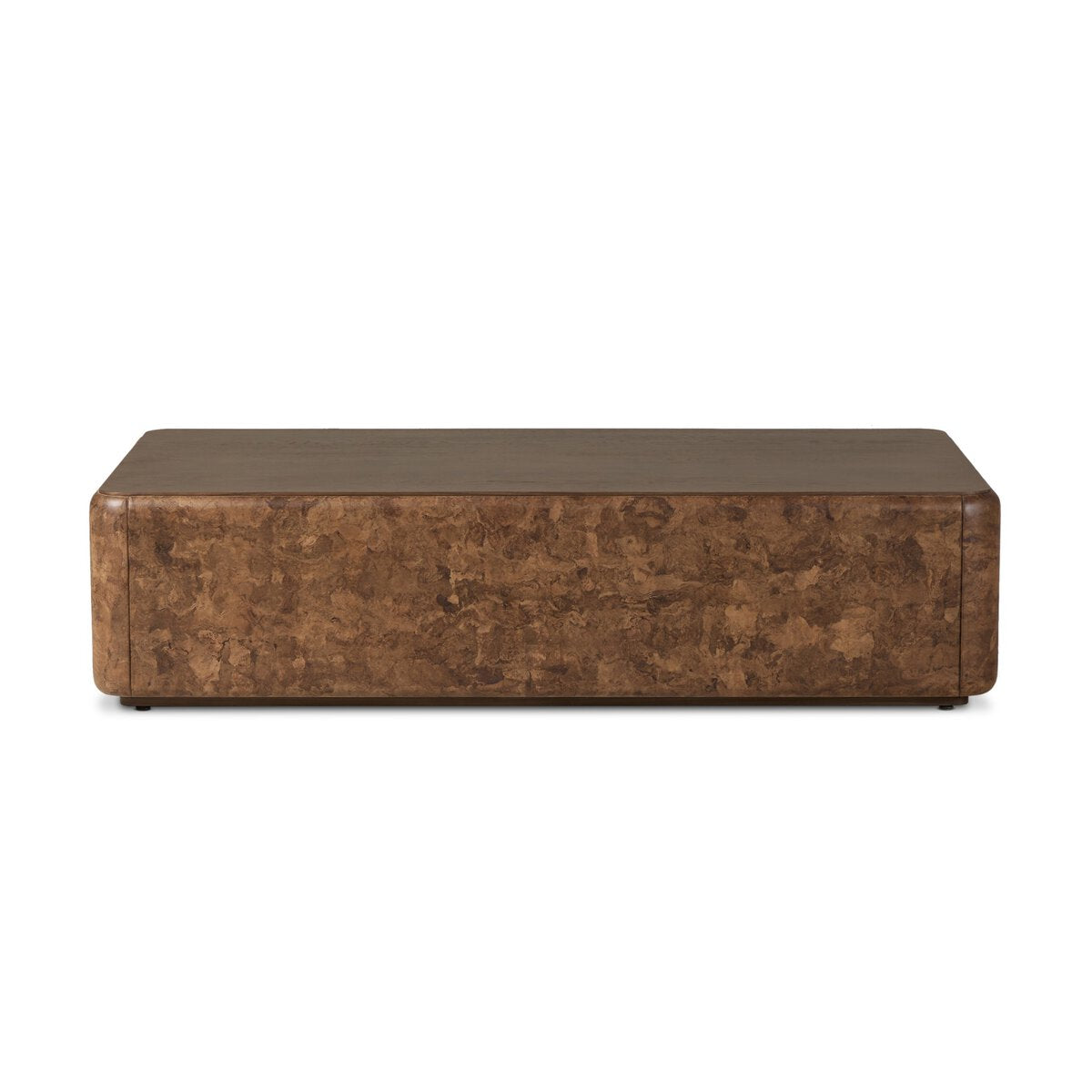 The Lola Coffee Table is a rectangular, low-profile piece with rounded edges and a textured brown finish, perfect for complementing various sofa sizes. Shown here against a white background.