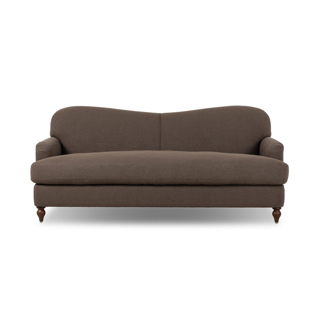 The Tiani Sofa, featuring brown upholstery, a gently curved backrest, rounded armrests, and wooden legs, is displayed against a white background—its versatile dimensions make it perfect for any space.