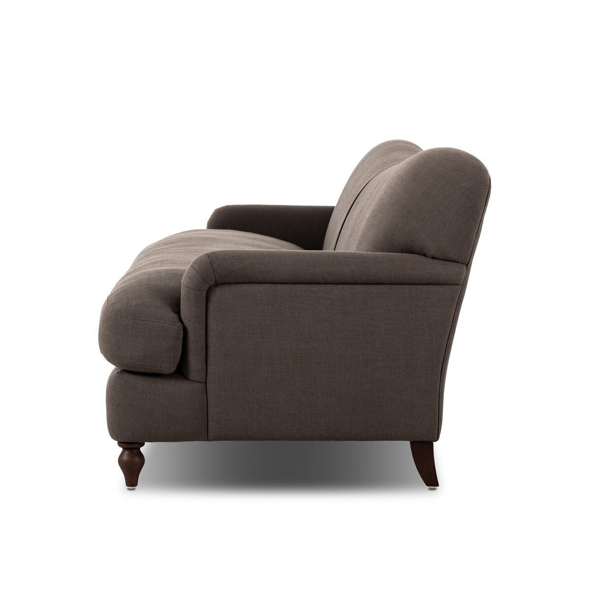 Side view of the Tiani Sofa—a dark brown upholstered design with a curved backrest, plush seat cushions, and wooden legs—set against a plain white background to showcase its elegant style and overall dimensions.