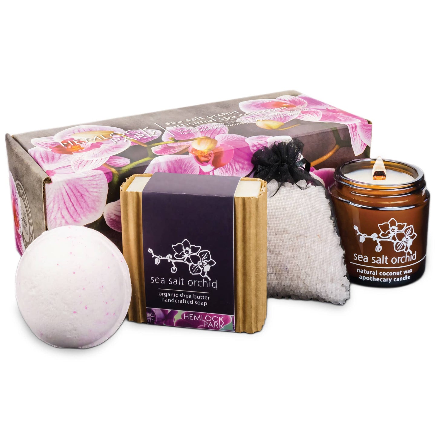 The Artisanal Spa & Candle Gift Box features a floral gift box with pink orchid accents, a bath bomb, sea salt orchid soap with organic shea butter, bath salts pouch, and a brown glass candle. Perfect for luxury self-care and gifting.