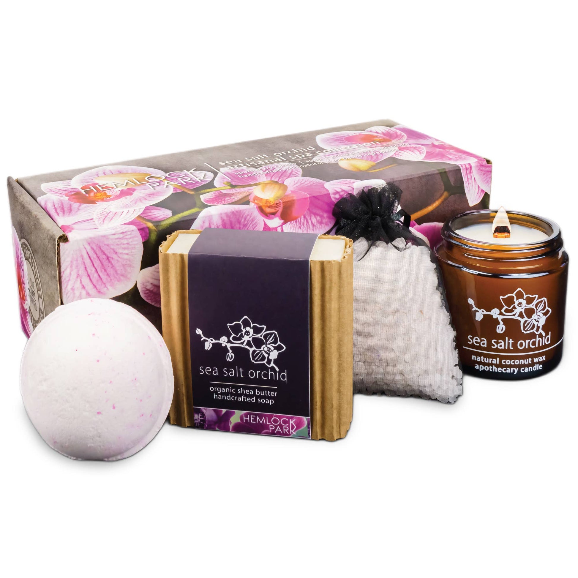 The Artisanal Spa & Candle Gift Box features a floral gift box with pink orchid accents, a bath bomb, sea salt orchid soap with organic shea butter, bath salts pouch, and a brown glass candle. Perfect for luxury self-care and gifting.