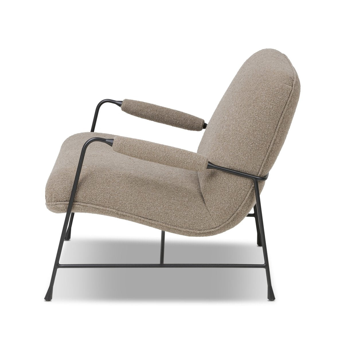 Side view of the Steel Upholstered Armchair, featuring beige cushions and armrests on a sleek black metal frame and legs, set against a plain white background.