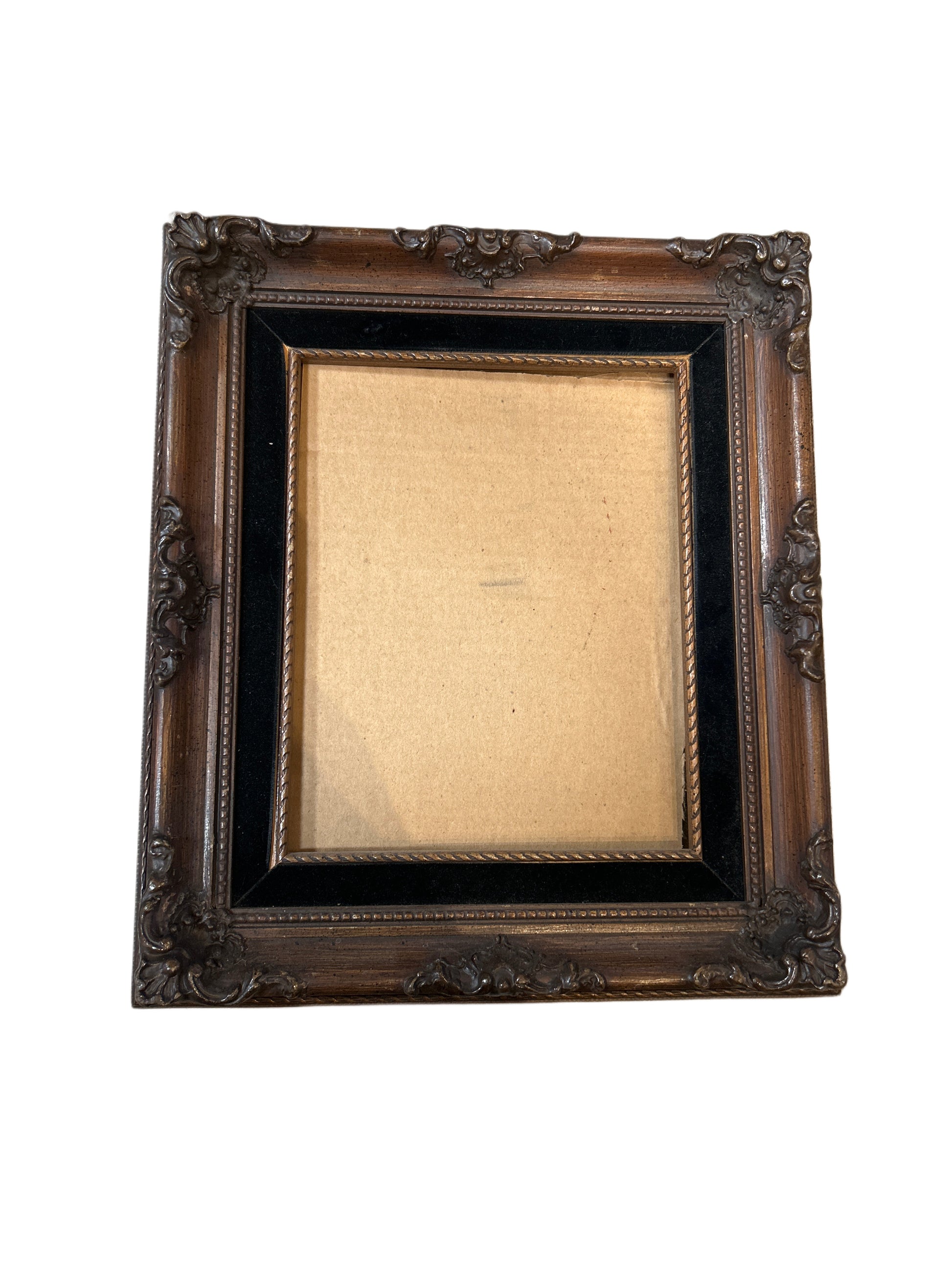 The Wood Frame is an empty, ornate rectangular picture frame featuring intricate carvings and a dark inner border, displayed against a white background.