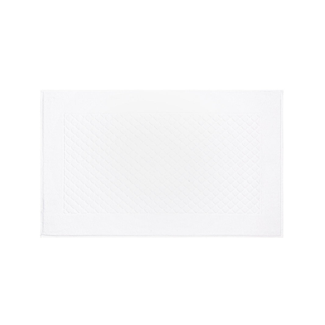 The Yves Delorme Bath Mat is a white, rectangular mat featuring a central diamond pattern and a plain border. Crafted from 100% cotton and displayed on a white background, this bath mat should be cared for according to the provided instructions to preserve its quality.