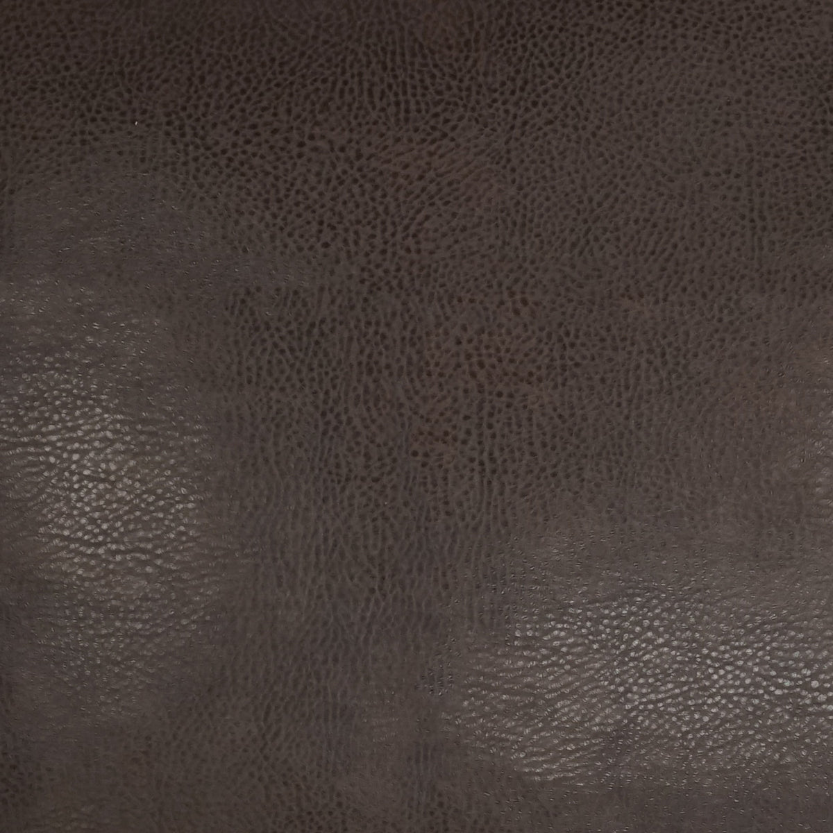 Rich dark brown textured leather surface with a subtle sheen, highlighting natural grain patterns and nuanced color variations—ideal for the Wrangler Pillow in a 24x24 size, complete with a plush polyester feather down insert.