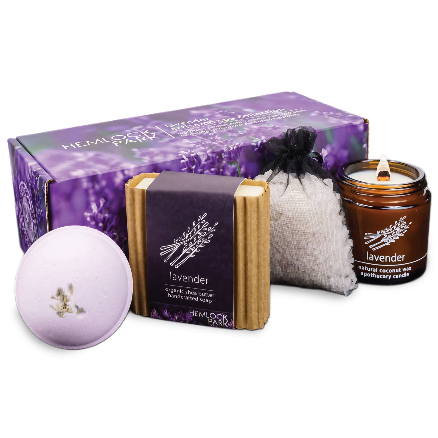 The Artisanal Spa & Candle Gift Box features vegan self-care essentials: a lavender soap bar with organic shea butter, bath bomb, bath salts in a black pouch, and a lavender candle, all presented before a floral purple gift box.