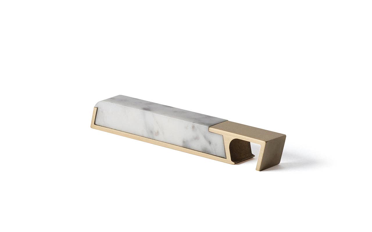 The Modern Marble Bottle Opener features a rectangular white marble handle with gray veins set in a gold-colored metal frame—an elegant, heirloom-quality piece displayed on a plain white background.