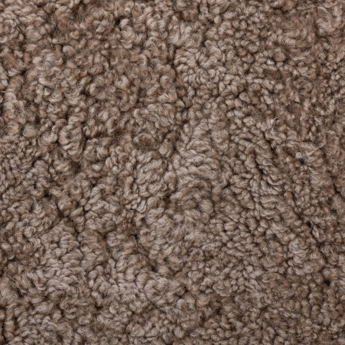Close-up of a textured, brown, woolly fabric surface with soft, curly fibers and a cozy look—like the upholstery on the Upholstered Wood Accent Chair.