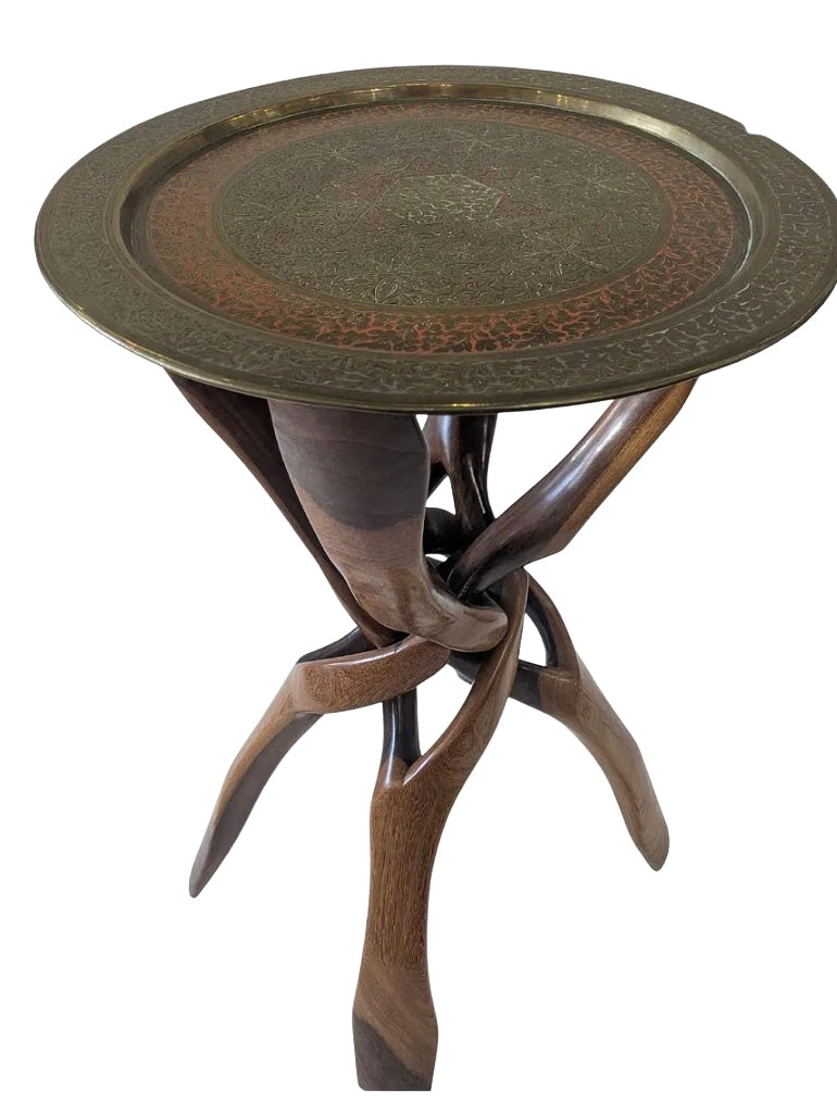 The Persian Rosewood and Brass Side Table features a round, floral-patterned brass plate with ornate designs atop a rosewood tripod base and three elegantly curved legs.