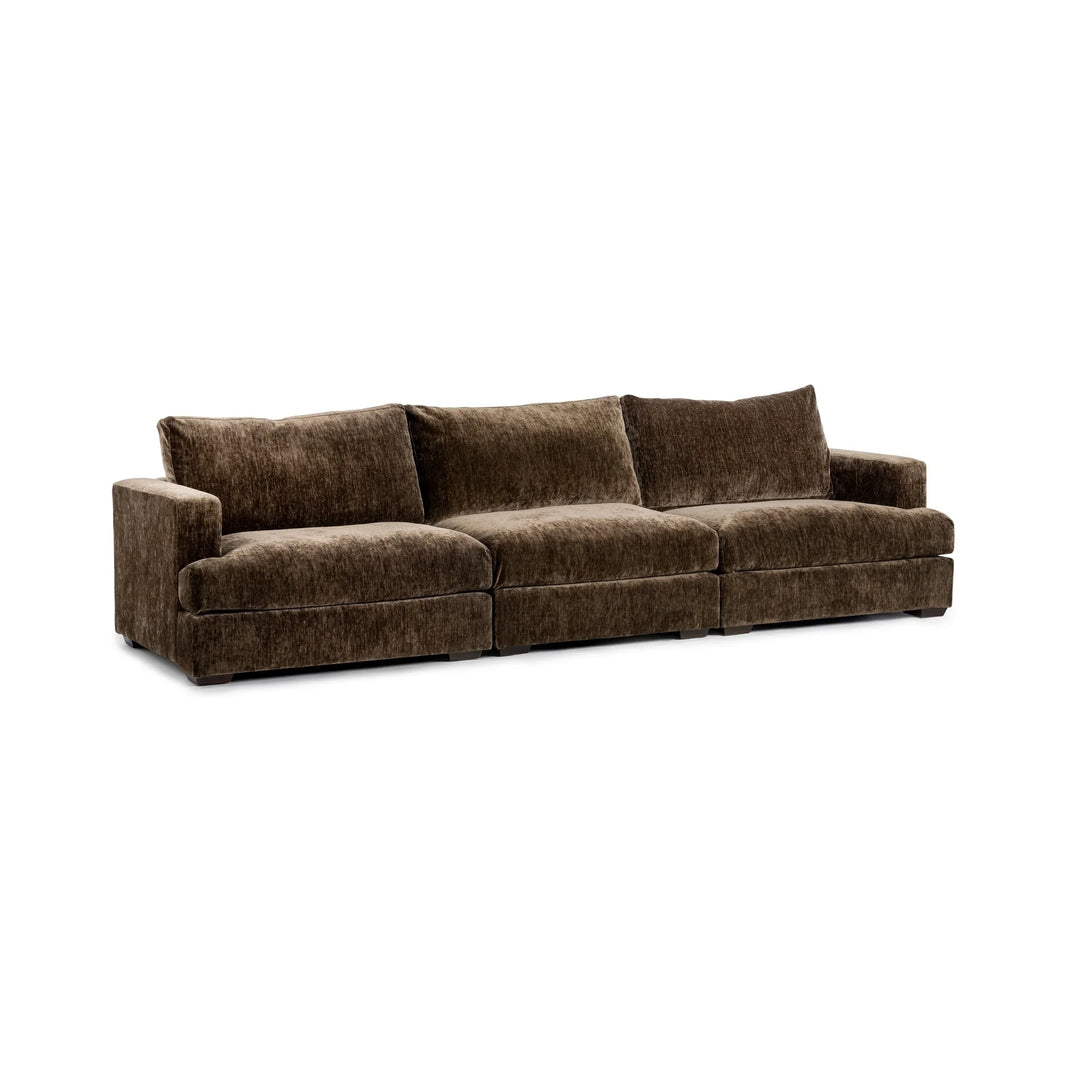 The Mossed Brown 3pc Sofa is a large, plush velvet piece in brown featuring three seat cushions and three backrests, low square arms, and a modern boxy silhouette—an inviting addition to any contemporary living room.