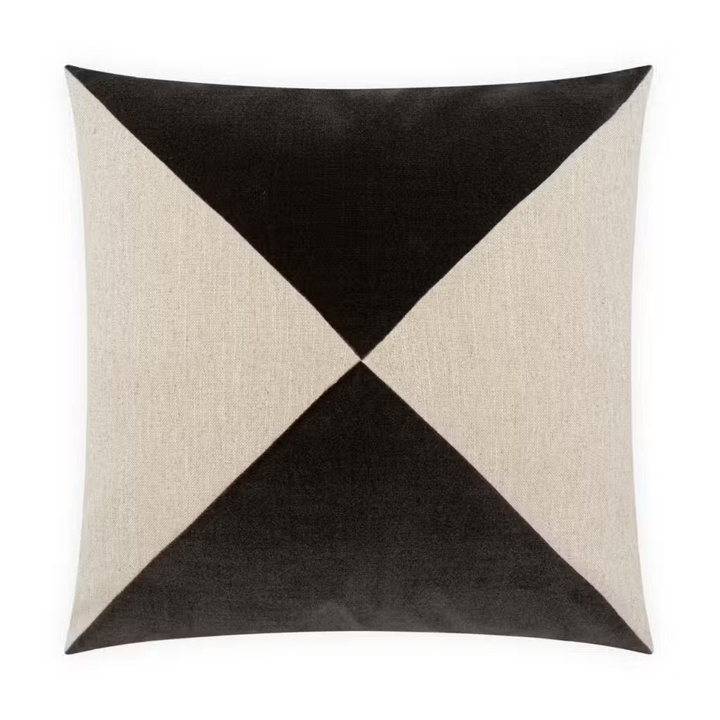 The Shadow Diamond Pillow is a 22x22 square cushion featuring a geometric pattern with four triangles—two black and two beige—arranged symmetrically in an hourglass-like design on a white background, as seen from a top-down perspective and crafted from polyester.