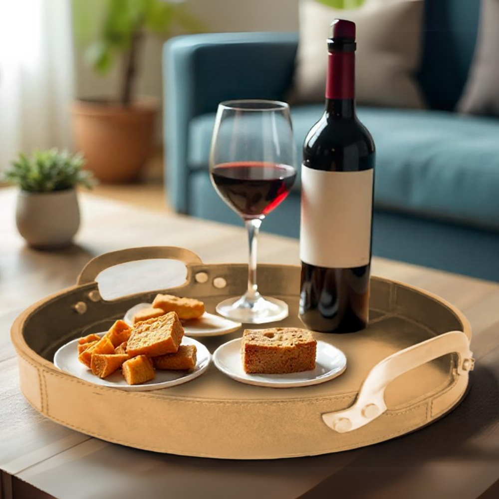 The Round Leather Stitched Tray with Brass Handle elegantly displays food and wine, turning any meal into a stylish serving experience.