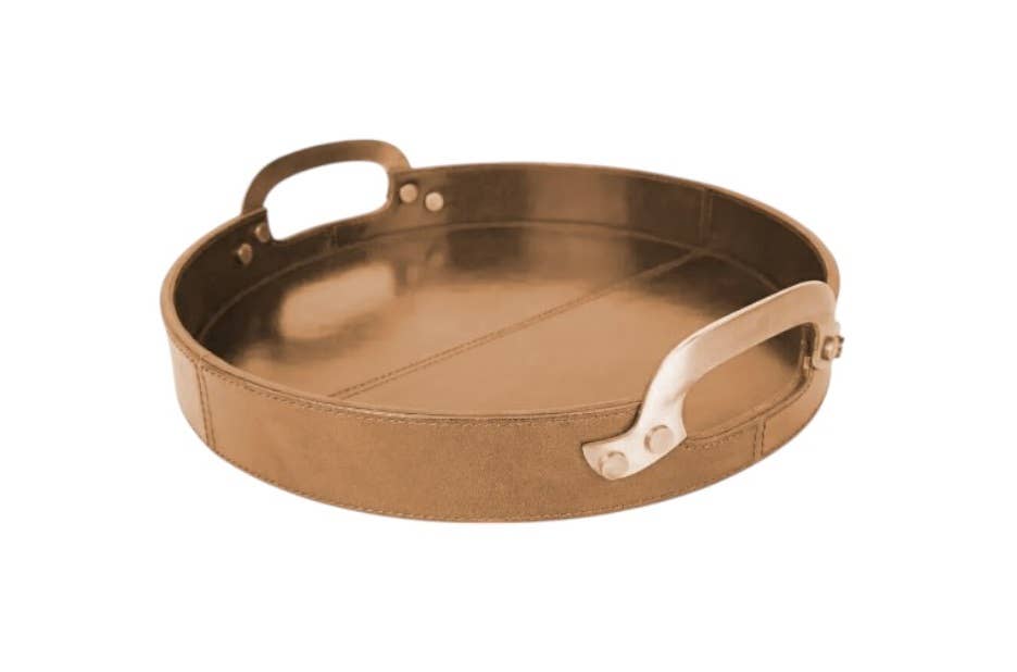 The Round Leather Stitched Tray with Brass Handle features a rich brown leather finish and brass handles, making it an elegant, decorative serving tray for any setting. Displayed on a white background, it adds timeless style to your décor.