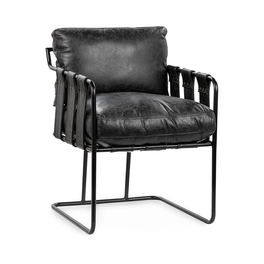 The Strap Dining Chair features a 21.5″W x 26.5″D x 32″H black metal frame, wide leather strap armrests and sides, and plush black cushions for a sleek, comfortable look.