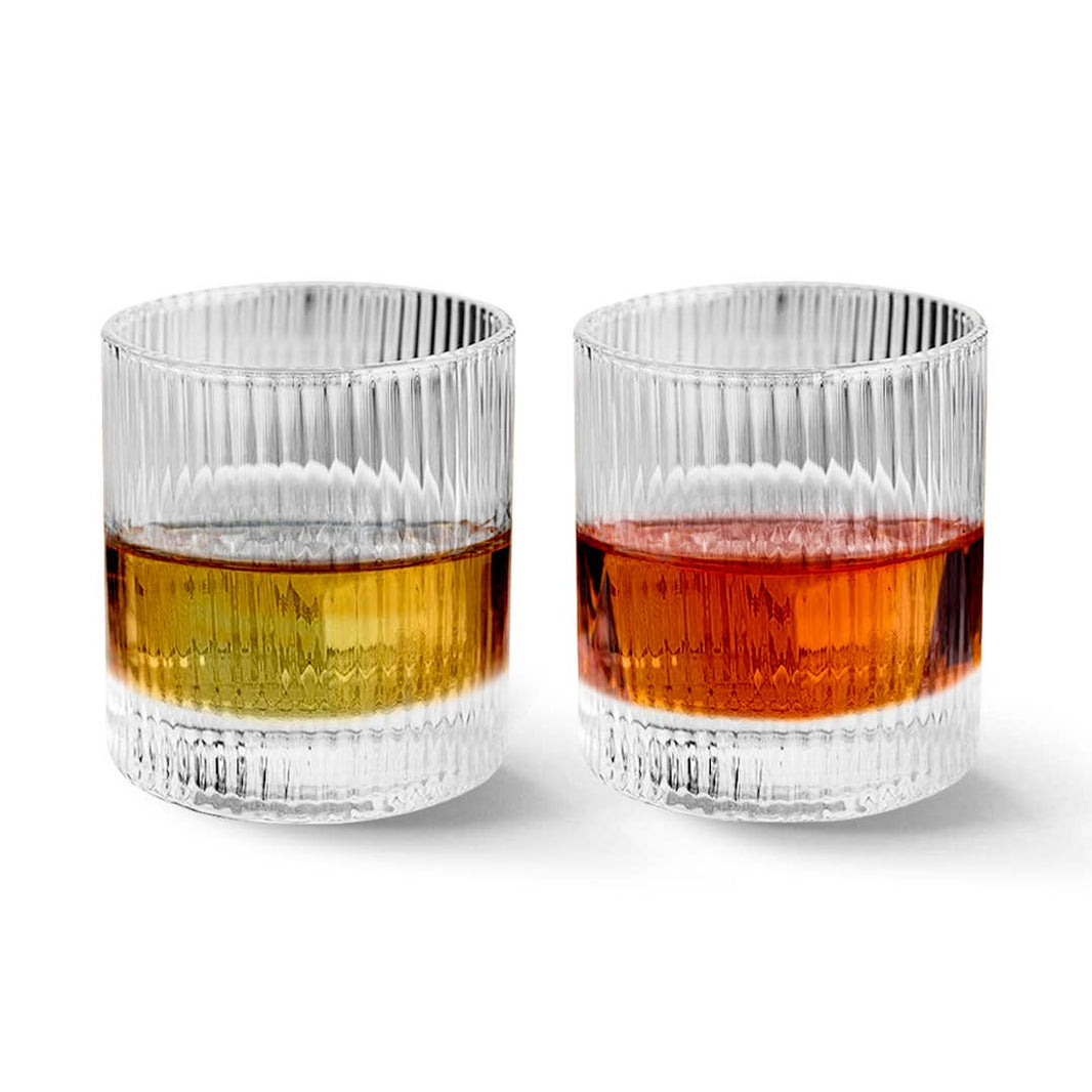 Two Vintage Straight Line Tumblers (10 oz each) are filled with golden yellow and deep amber liquids and set side by side against a plain white background.