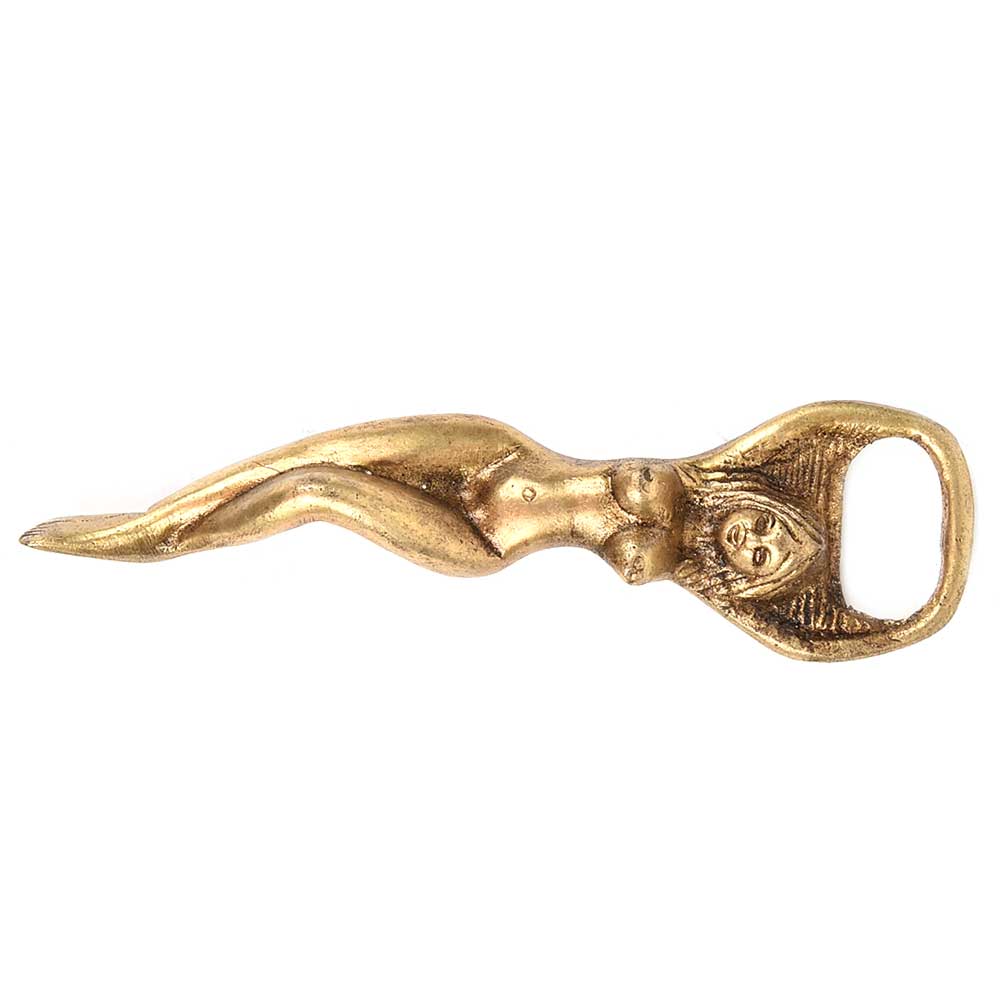 The Lady Bottle Opener Gold is a gold-colored bottle opener shaped like a reclining nude woman, with the opener forming a loop at her outstretched arms above her head.