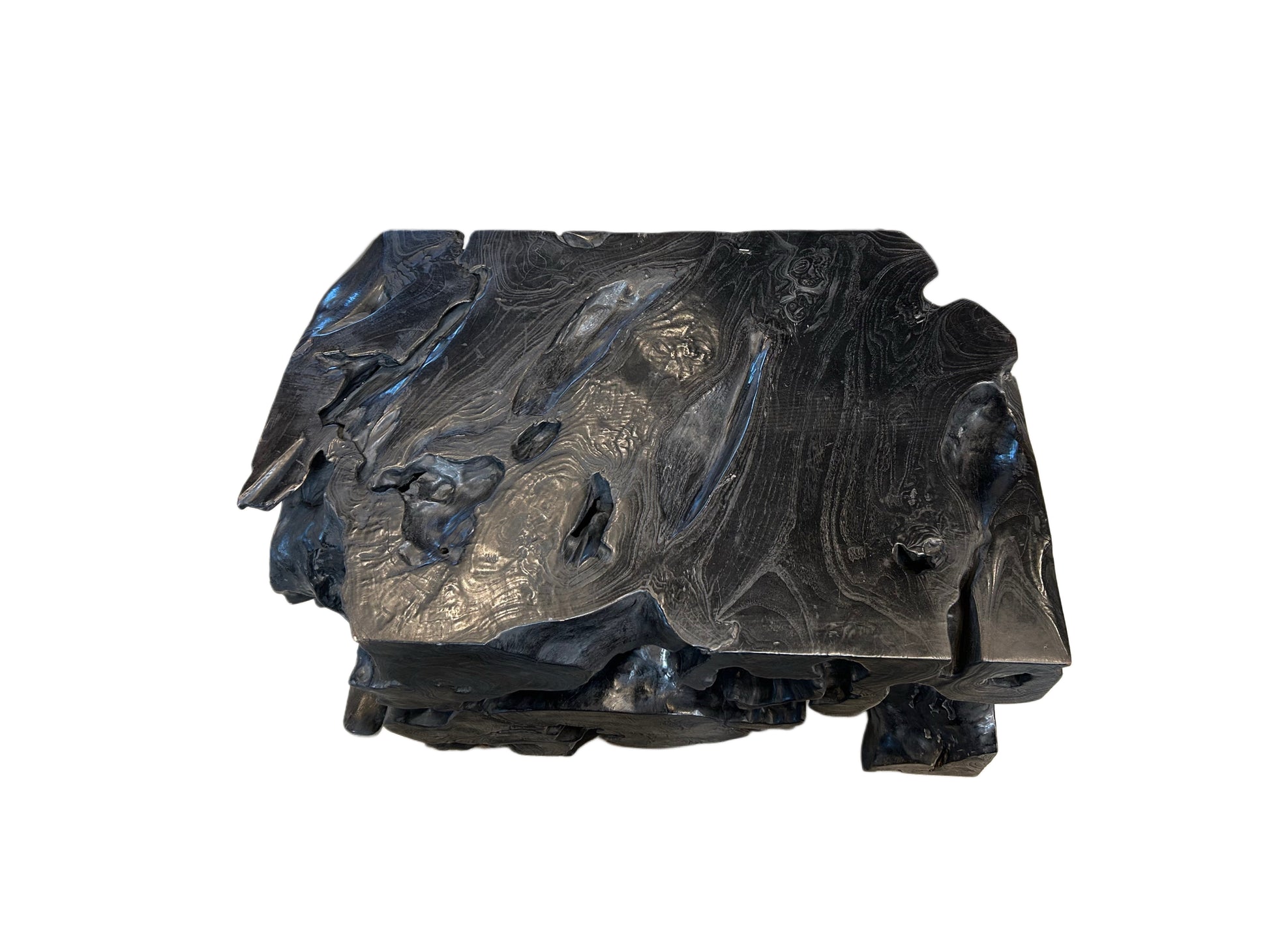 The EBONIZED OLD GROWTH TEAK STUMP is a dark, glossy, irregular chunk with textured swirls and rough edges, resembling volcanic rock or a large wood block against a white background.