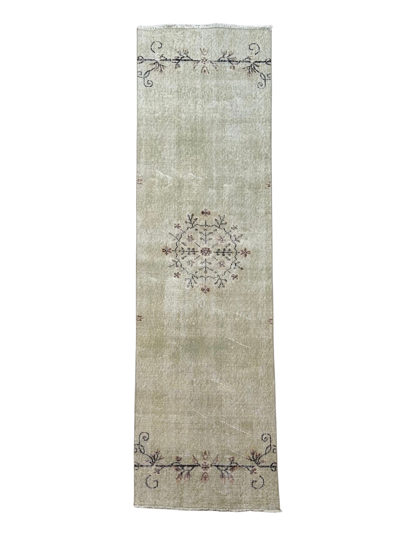 The Vintage Turkish Runner 2x8 is a long, light beige rug with minimalist floral accents at each end and a central circular motif. Its plush background in muted tones adds an elegant touch to your space.