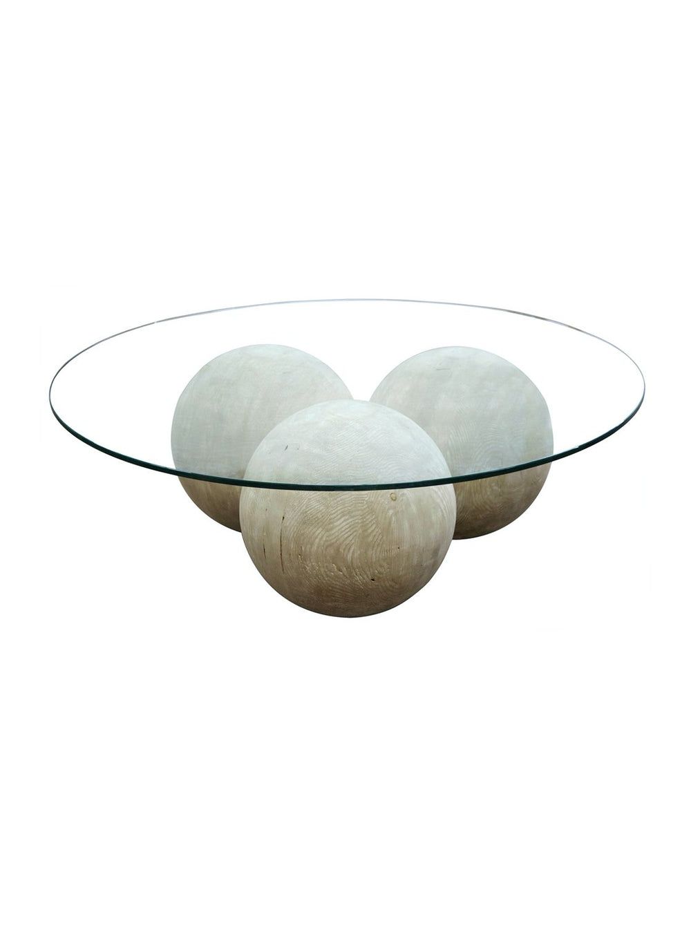 The Cannon Round Coffee Table features clean lines and a glass top, supported by three large, light wood spheres arranged in a triangular formation.