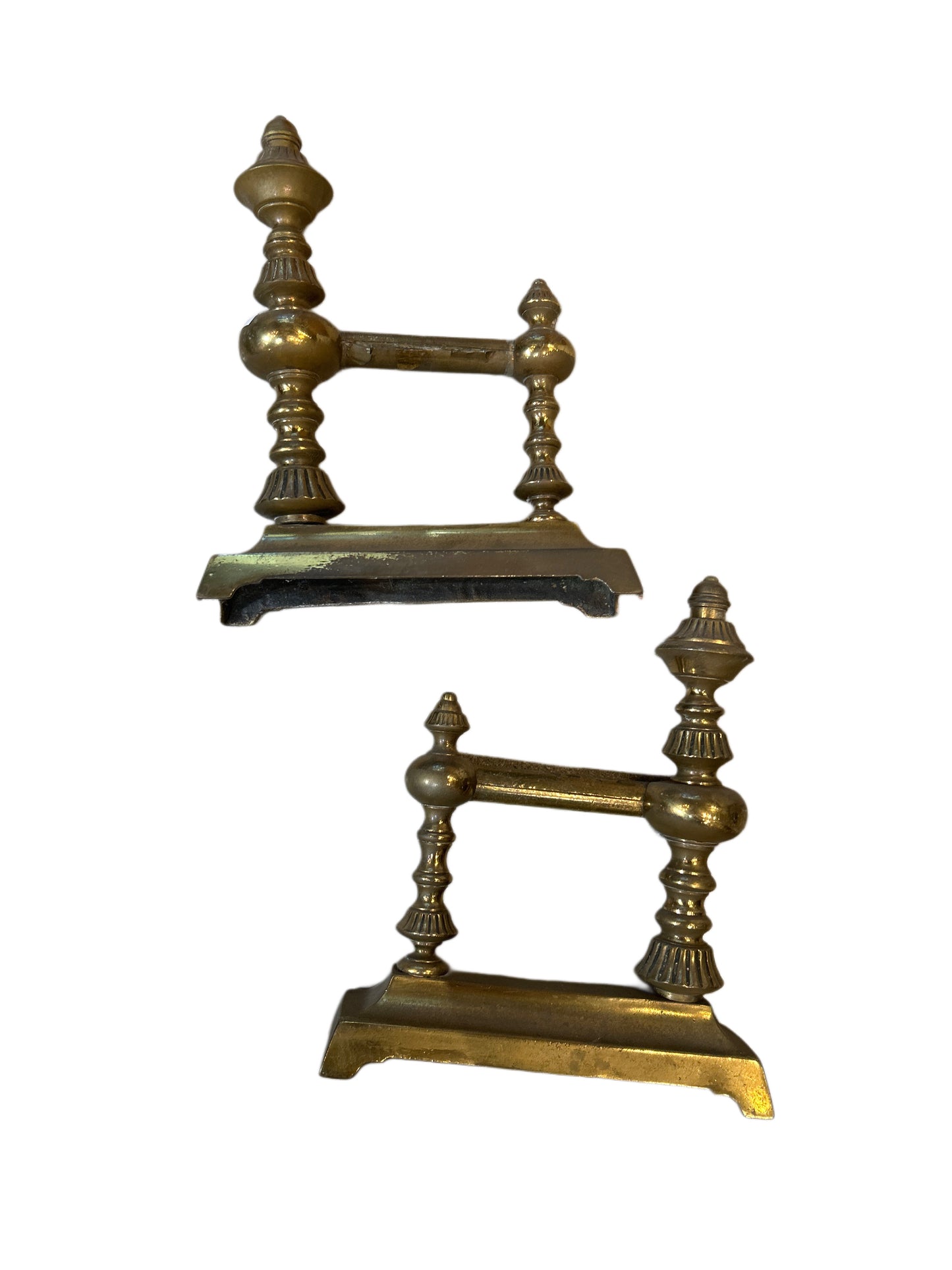 A pair of Angle Irons with decorative turned brass details, designed to hold logs in a fireplace, displayed against a white background.