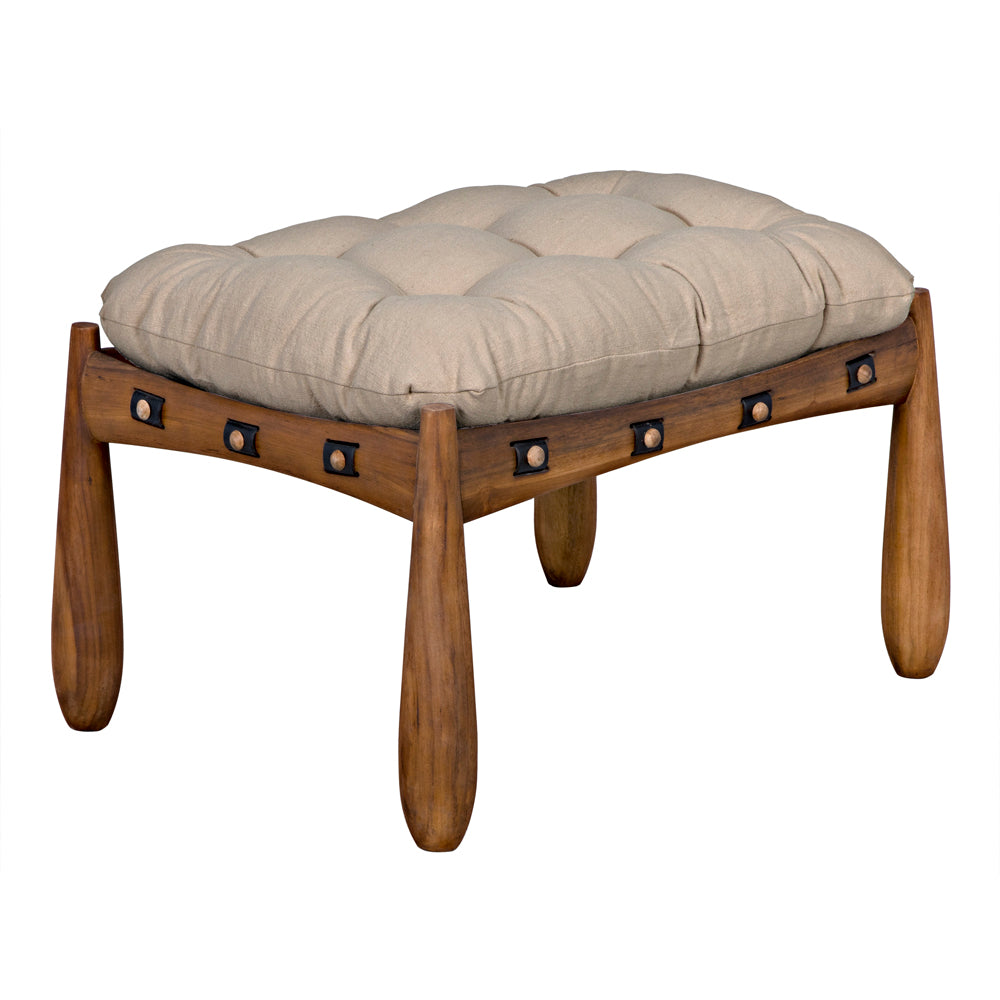 The Teak Stool with Tufted Upholstery features rounded wooden legs, a thick beige cushion in premium fabric, and black metal rivets accenting its modern frame.
