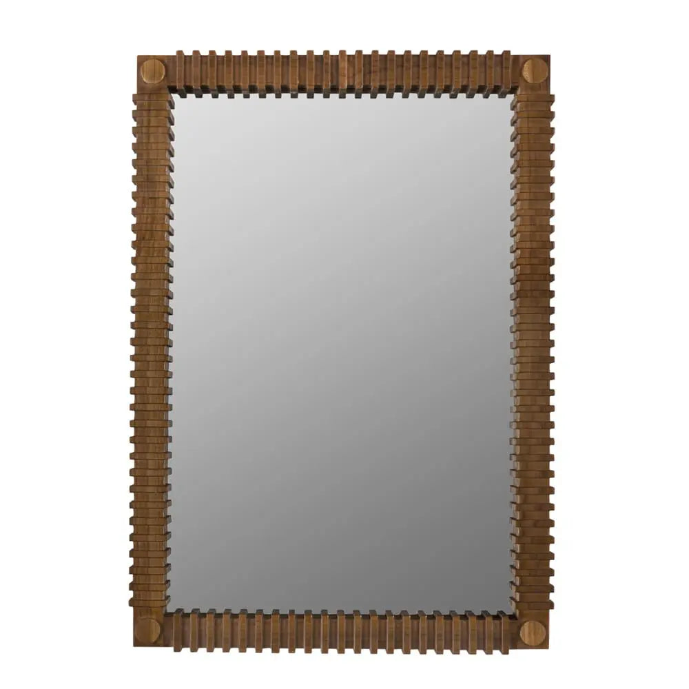 The Sculpted Teak Mirror features a rectangular wooden frame with a geometric, ridged pattern on all sides and a medium brown finish for a modern yet rustic look. Dimensions: 26W x 2D x 36H.