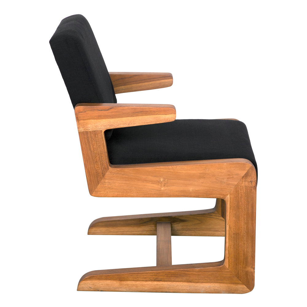 The Bruce Chair features a teak frame with black cotton cushioned seat and backrest. Its unique angular base and smooth wood grain make it ideal for contemporary living spaces.