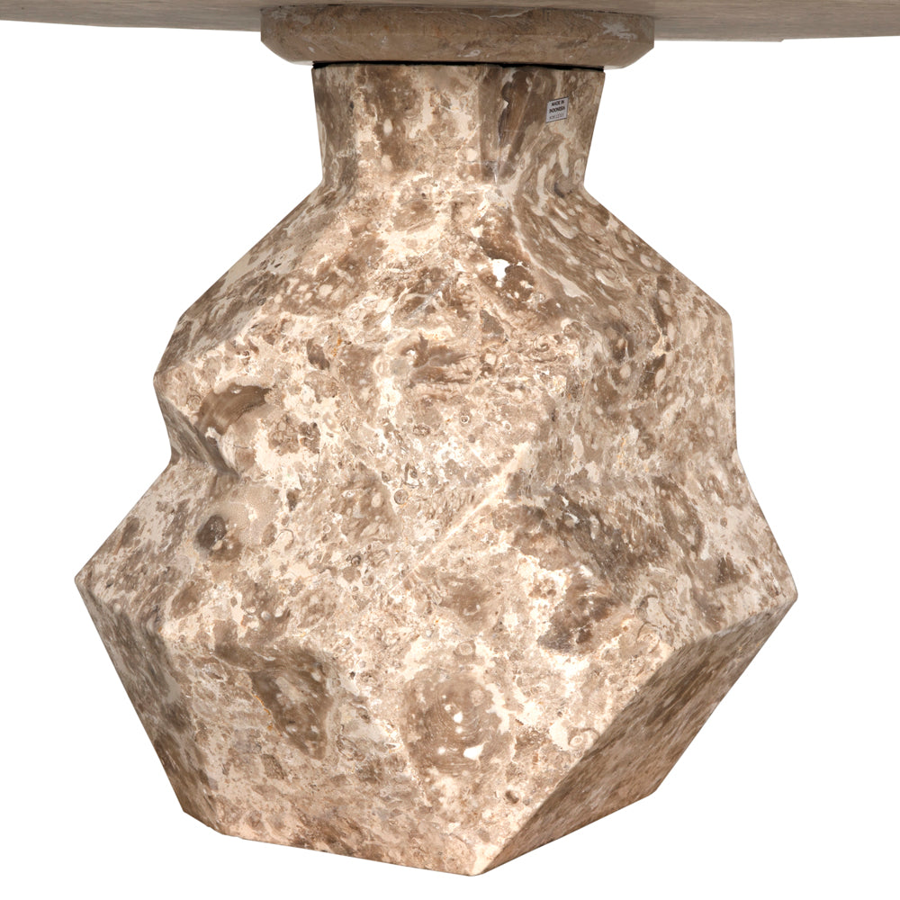 A close-up of the Rind Table’s geometric, faceted base crafted from white marble with natural stone patterns—a striking accent for any contemporary space.