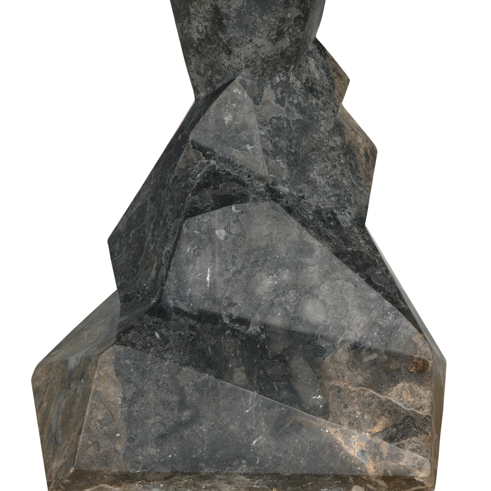 A close-up of the Tilden Console in black marble, featuring sharp geometric facets and a polished surface, reminiscent of a modern entryway table, isolated on a white background.