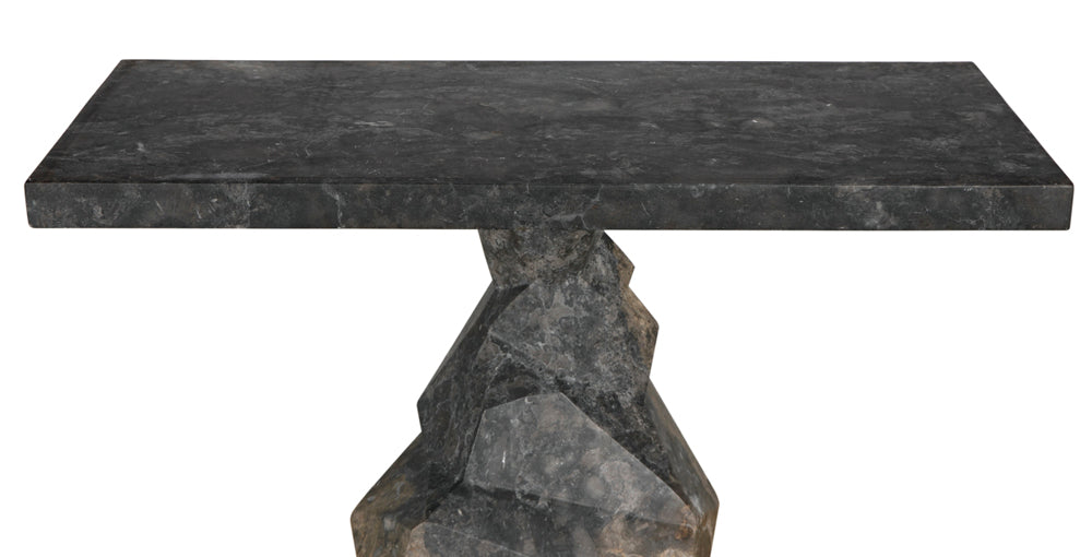 The Tilden Console in black marble features a rectangular top and geometric angular pedestal base, creating a minimalist statement piece that stands out beautifully against a white background.