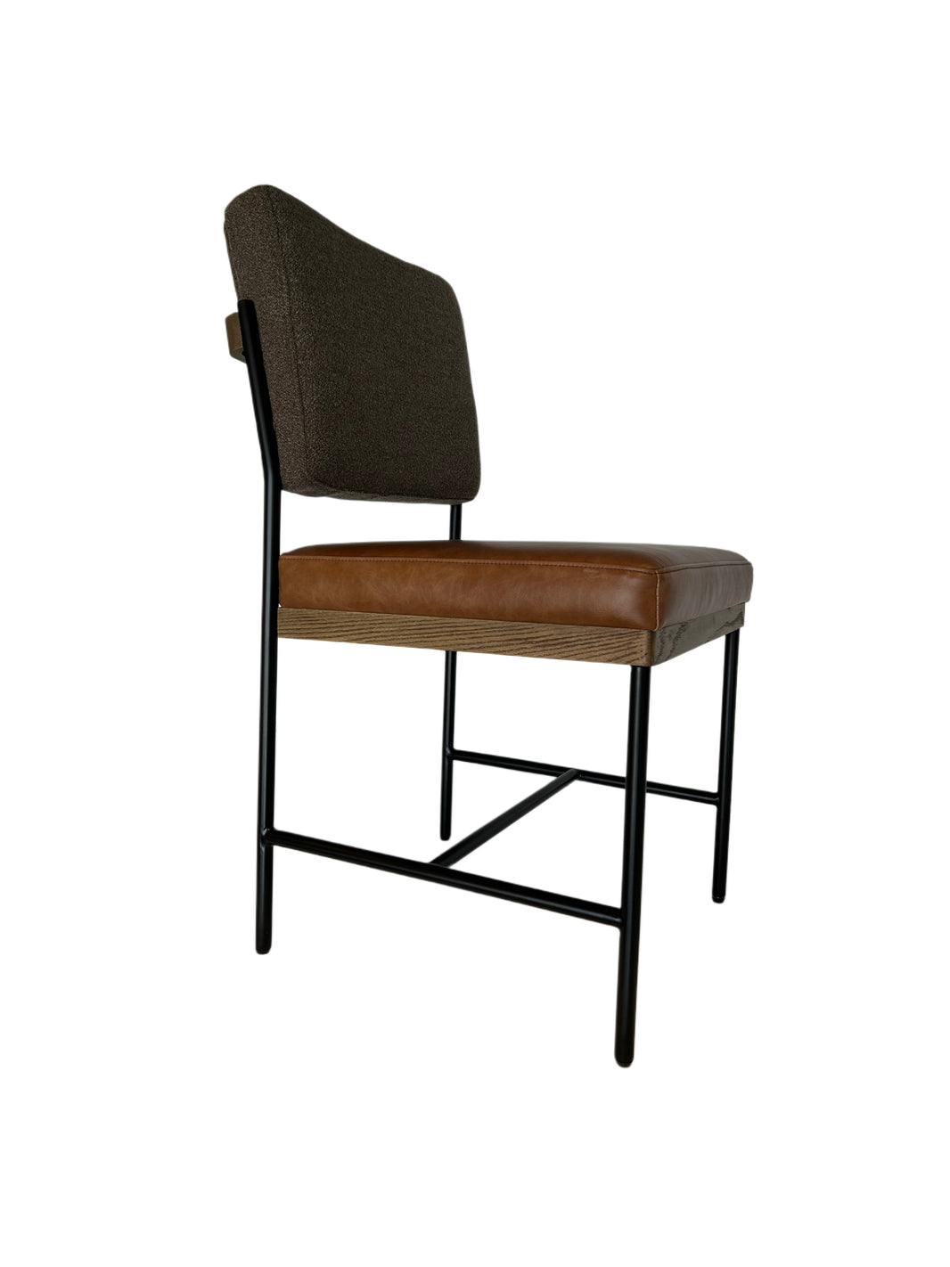 Side view of the Custom Boucle & Tan Leather Side Chair featuring a dark boucle backrest, tan leather seat, wooden edge detailing, and black metal legs, set against a white background.