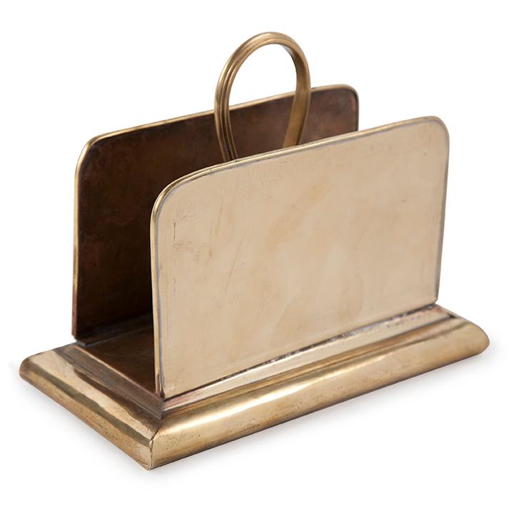 The Solid Brass Letter Holder features two flat panels and a curved handle on a rectangular base, offering a timeless way to organize mail or documents with classic vintage style.