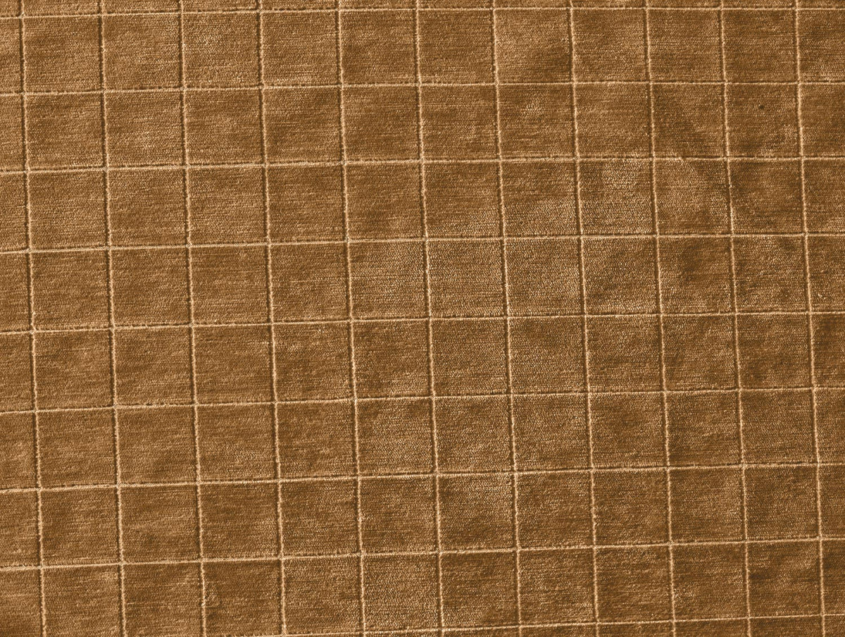 The Cumin Grid Pillow features soft, velvety brown fabric adorned with a grid pattern of evenly spaced vertical and horizontal stitched lines that form subtle square shapes. Its luxurious texture and elegant design make it the perfect accent for any down or feather pillow.