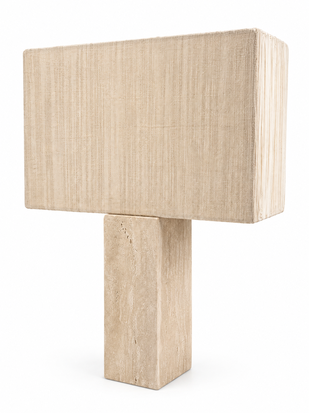 The Travertine Table Lamp features a rectangular beige fabric shade and a matching textured rectangular stone base, set against a white background. The overall dimensions are 20″W x 10″D x 30″H.
