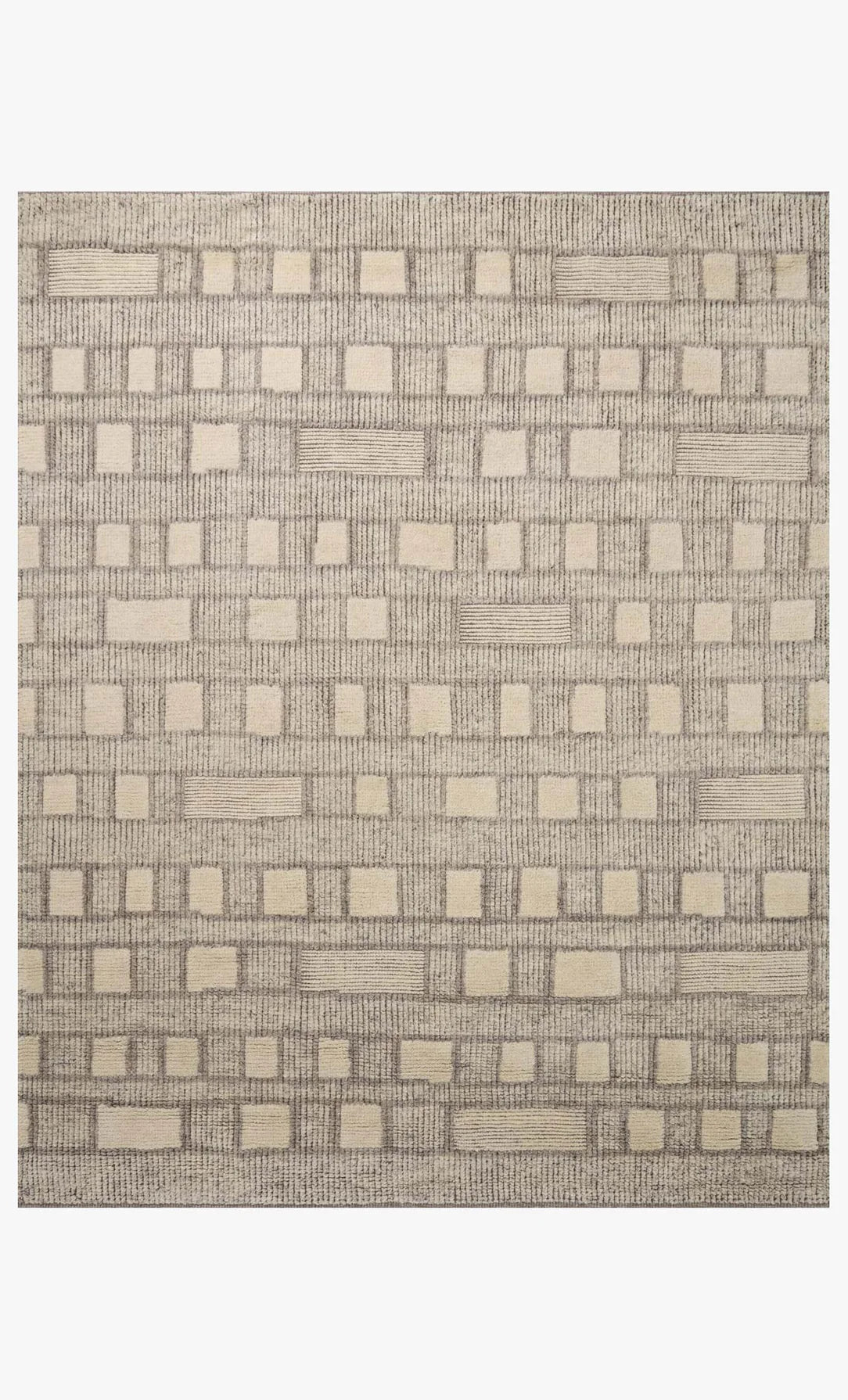 The Indian Wool Tribal Rug (8'6" x 11'6") features a beige and light brown geometric pattern with textured raised squares. Made from 100% wool, it's available in multiple sizes.