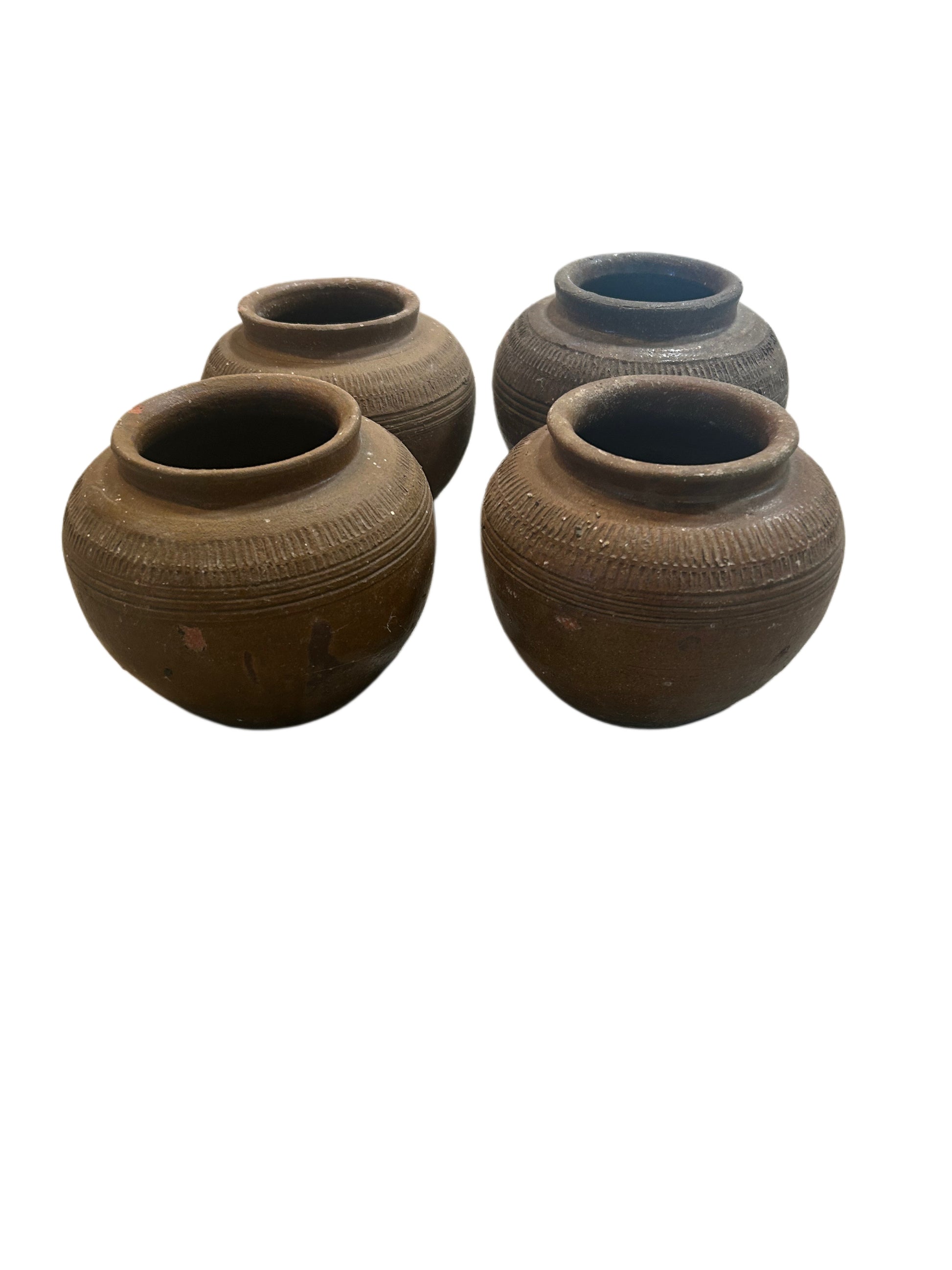 Four Small Brown Vintage Pots with wide openings and textured horizontal patterns, arranged closely together on a white background. Each Small Brown Vintage Pot is sold individually.