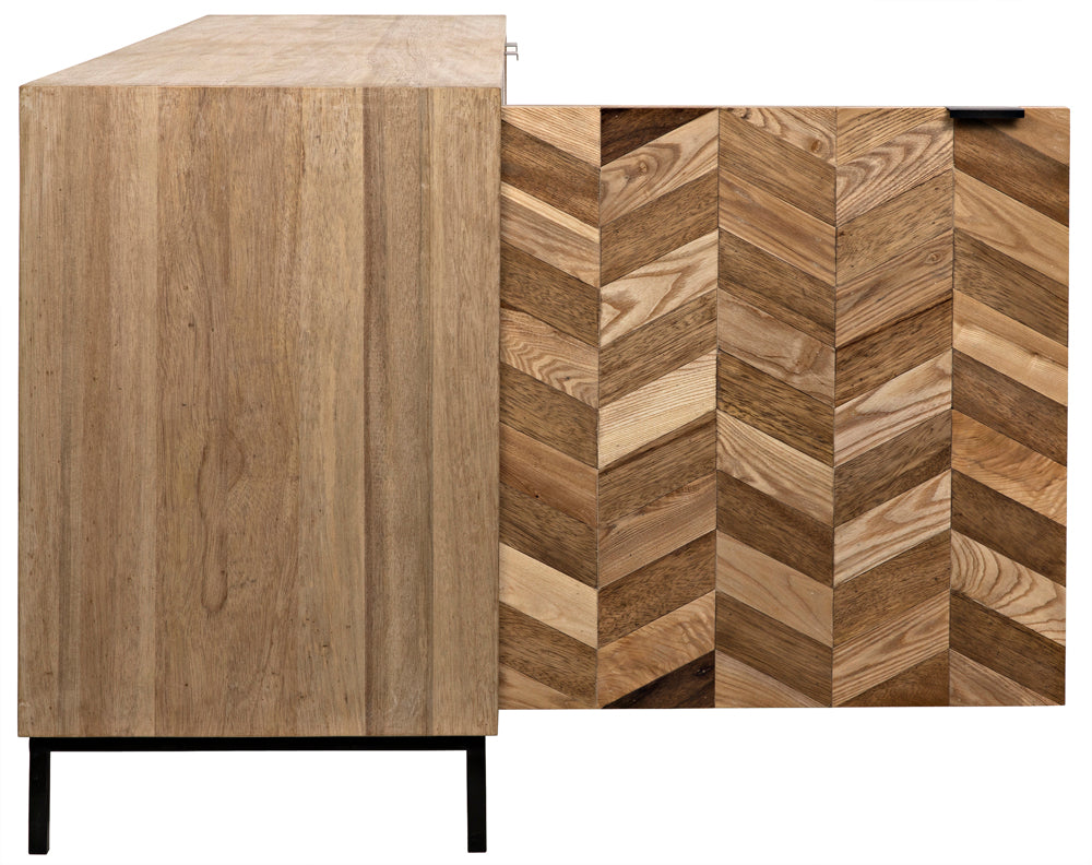The Herringbone Sideboard features black metal legs, plain wood grain on the left, and a bold herringbone pattern on the right. One door is slightly open, highlighting its unique blend of wood tones.
