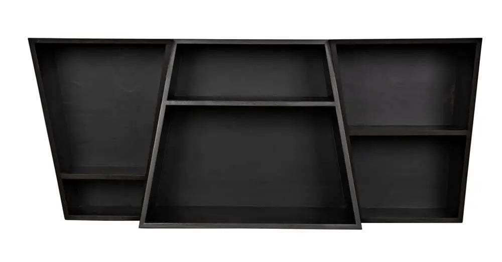 The Ebony Walnut Sideboard/Shelving Unit features an asymmetrical black wood design with five uniquely shaped compartments, ideal for displaying items above an office desk against a white background.