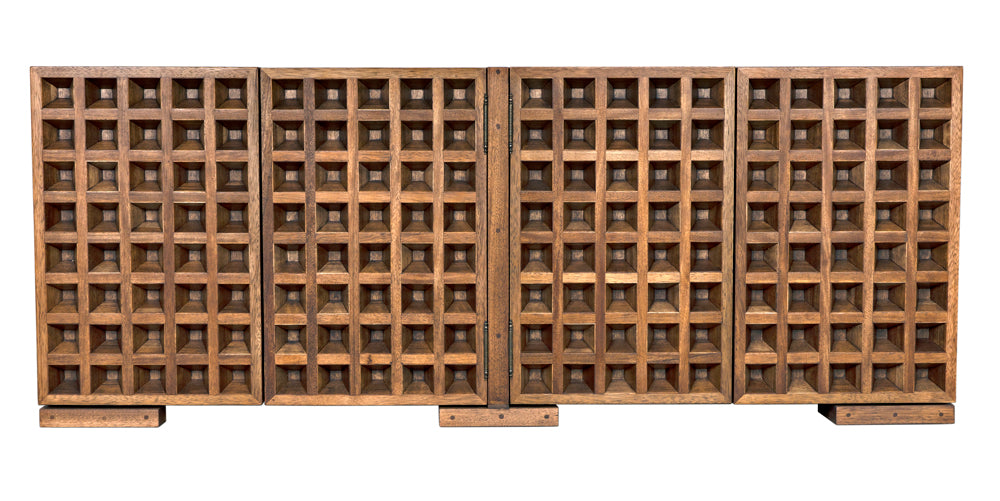 The Nuala Sideboard is a large, rectangular wooden sideboard with four grid-style sections for horizontal wine bottle storage. Its medium brown rustic finish and classic design make it a striking statement piece for any space.