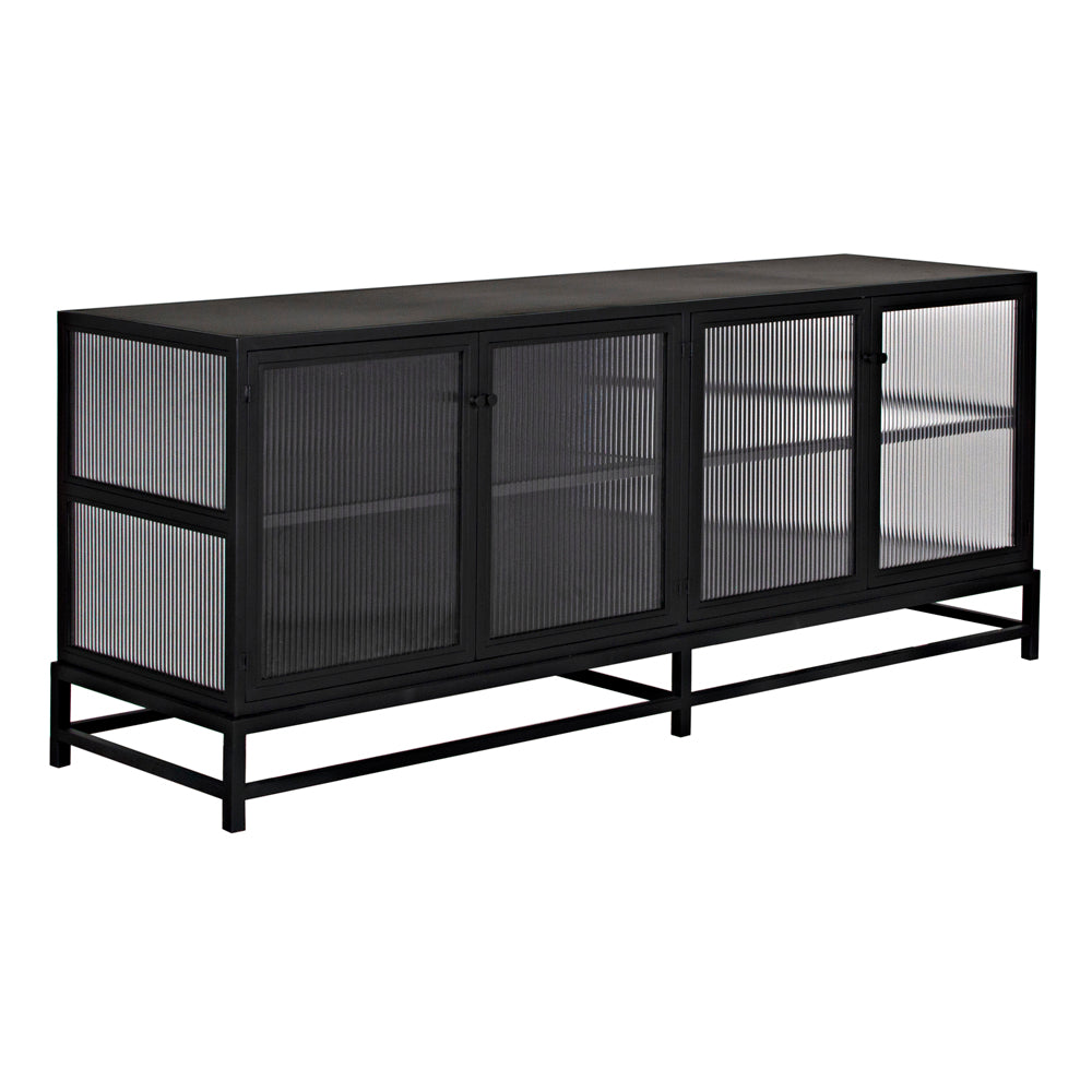 The Chandler 4 Door Sideboard, Black Iron, features a sleek black iron frame and ribbed glass panels on the front and sides, plus two interior shelves behind four doors for ample storage in a minimalist design.