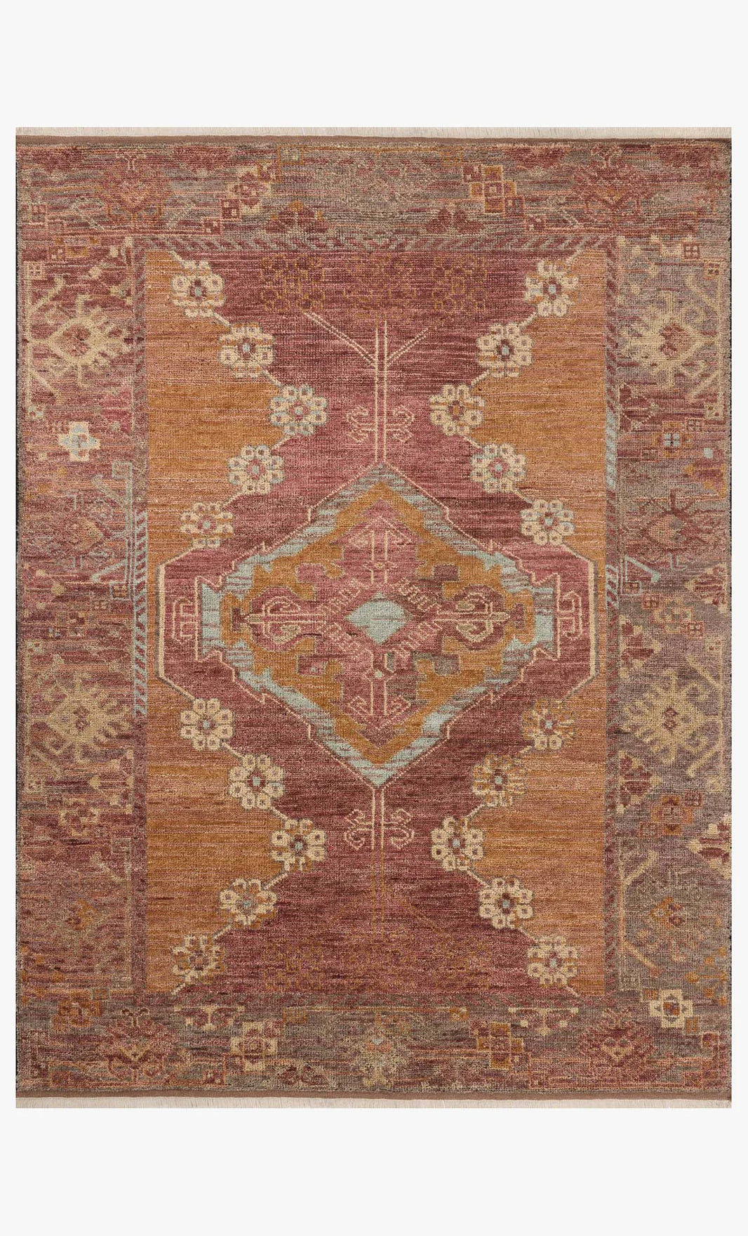The Spice Rug (8'-6" x 11'-6") is a handcrafted rectangular area rug made from 100% wool, featuring a distressed vintage design with a central geometric medallion in muted rust, gold, and beige tones, decorative patterns, and earthy borders.